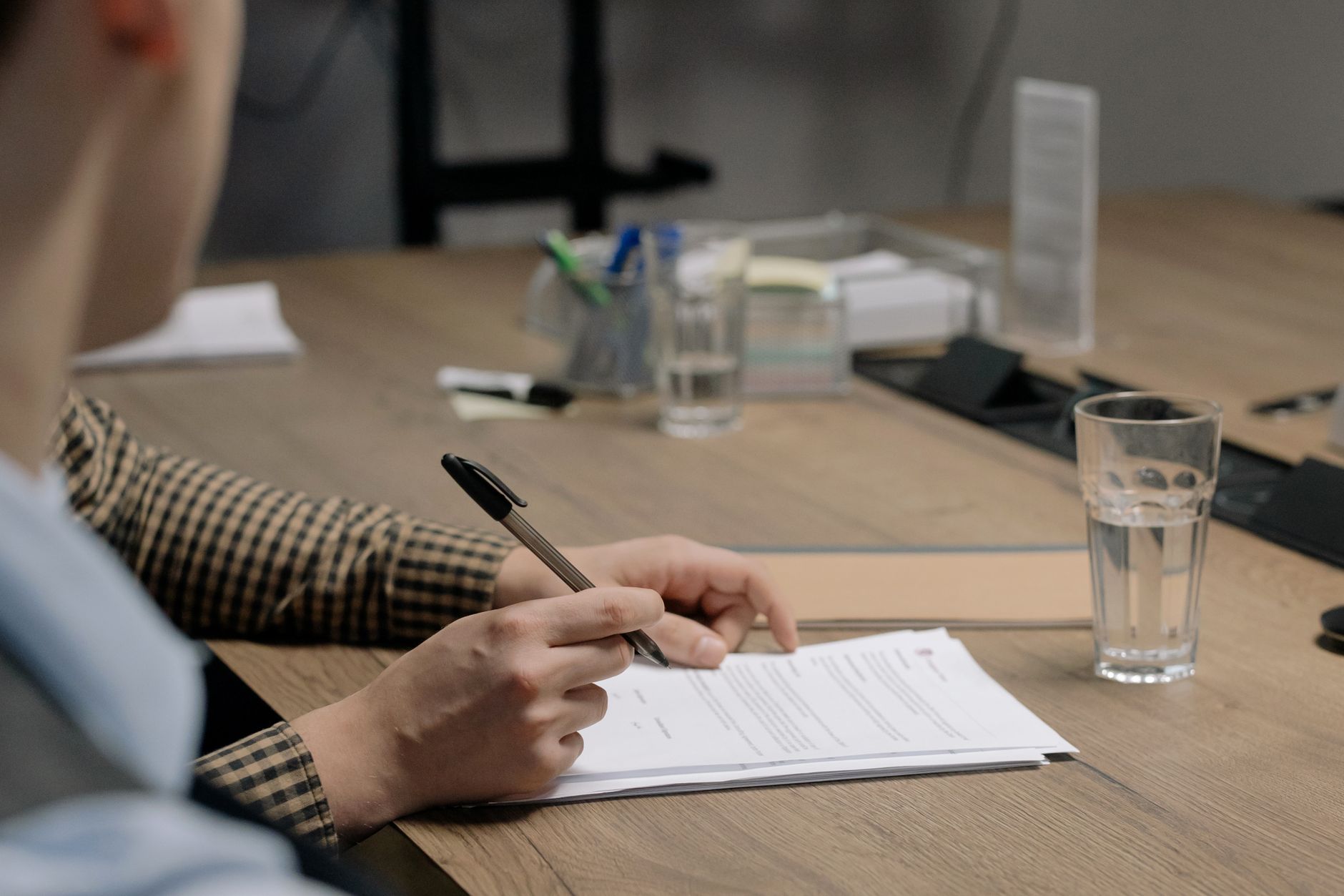 Founder signing an acquisition agreement that sets the earnout structure