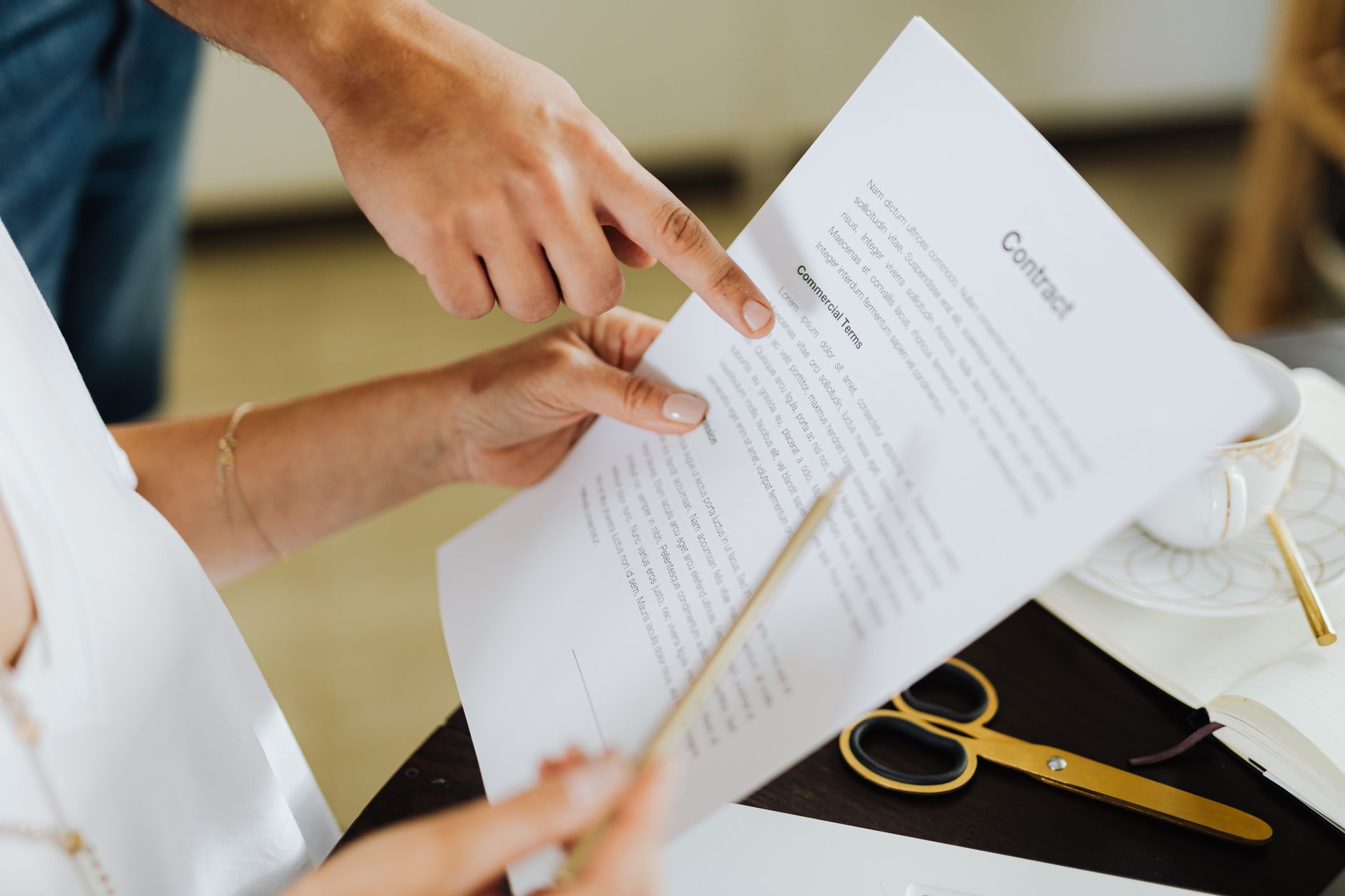 A founder and lender negotiating the wording of a material adverse change clause across a desk