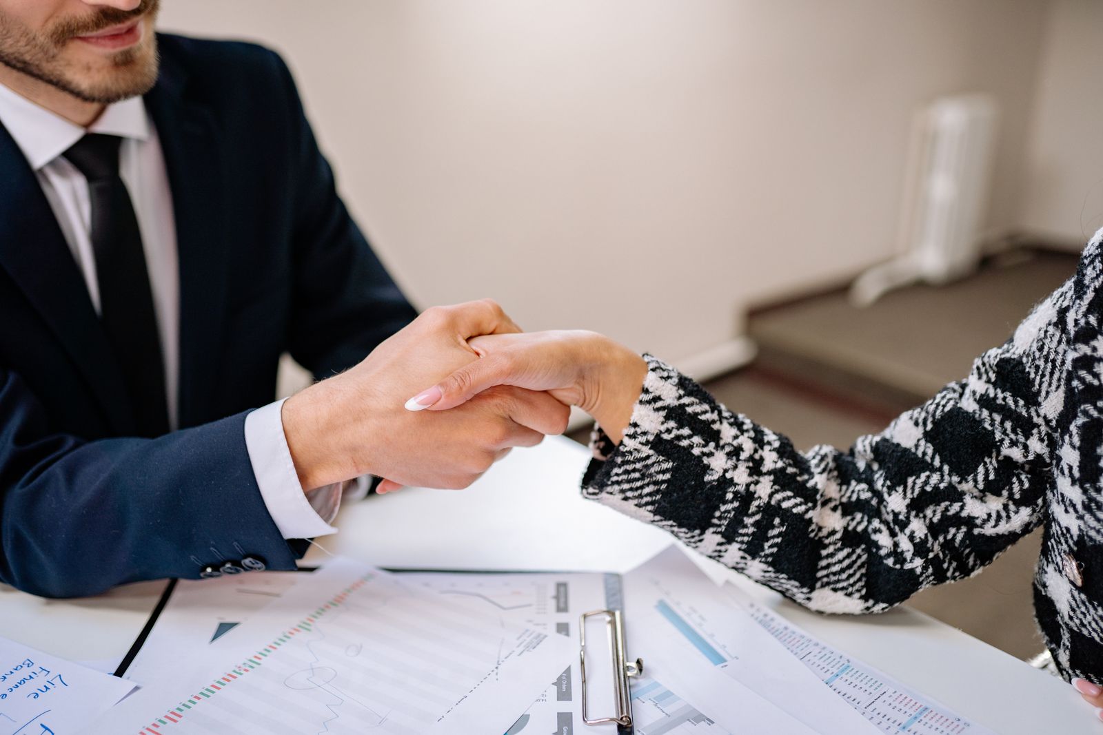Acquirer and seller shaking hands on a price set by a defensible synergy model