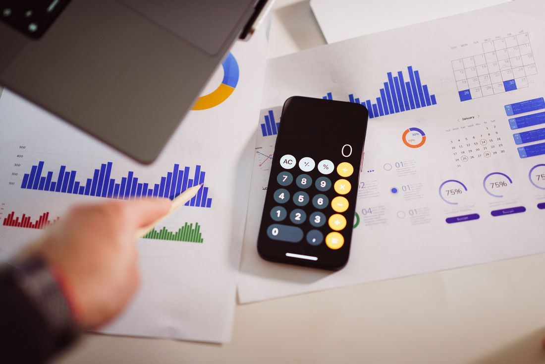 Financial dashboards and a calculator used to test the metrics behind a tranche milestone