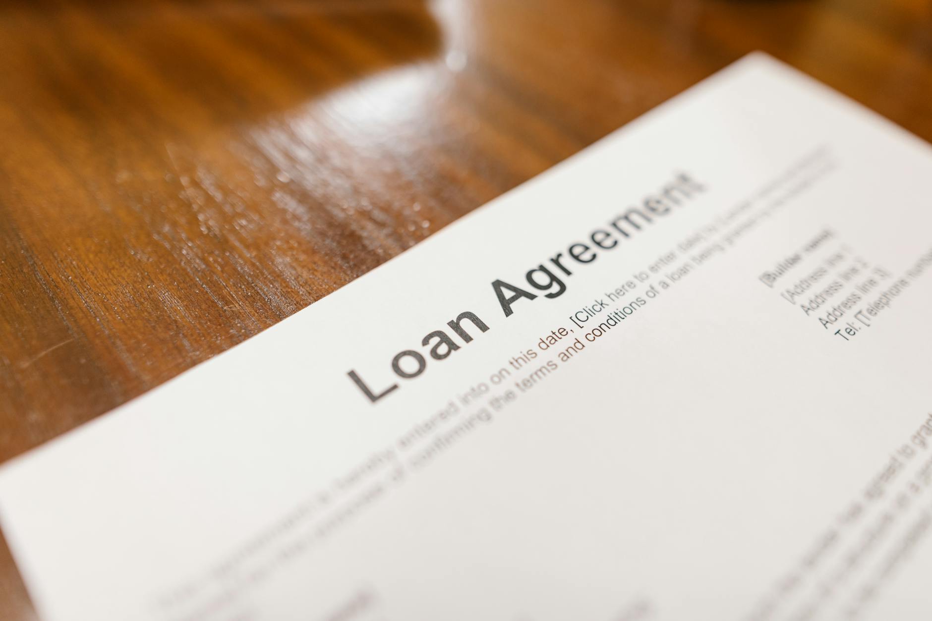 A loan agreement on a desk, the kind of financing layer a mezzanine deal adds to the capital stack