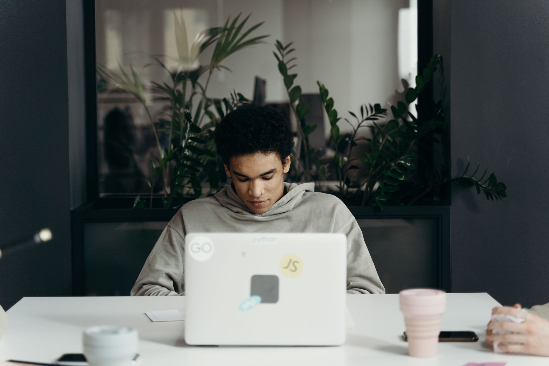 A founder focused at a laptop, growing a company without giving away equity