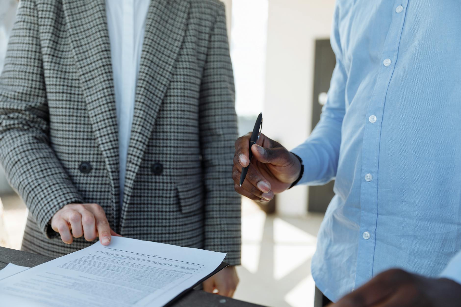 Two people signing a financing agreement, the point where a valuation turns into a real deal